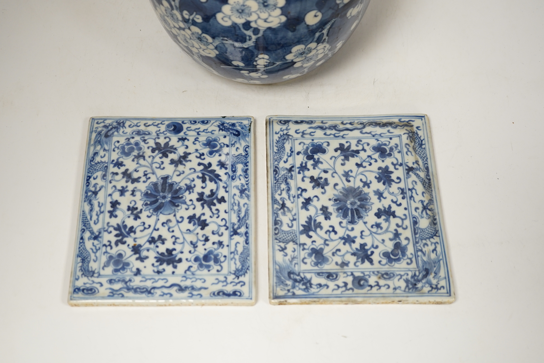 A 19th century Chinese blue and white prunus jar and cover, together with two similar tiles, jar 21cm